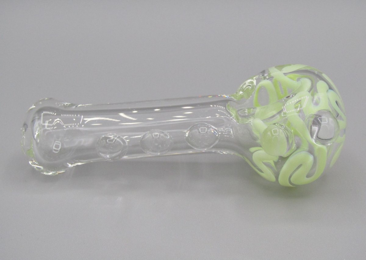 Right side view 4" swirl spoon hand pipe, clear glass w/ multiple knockers.