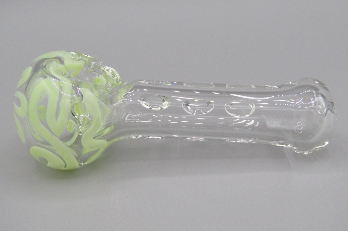 Left side view 4" swirl spoon hand pipe, clear glass w/ multiple knockers.