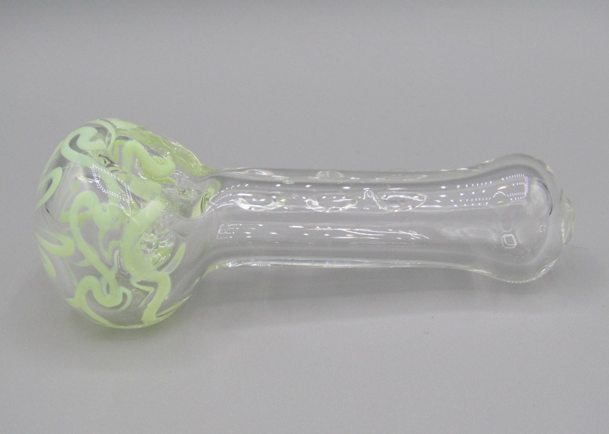 Left side view 4" swirl spoon hand pipe, clear glass w/ multiple knockers.